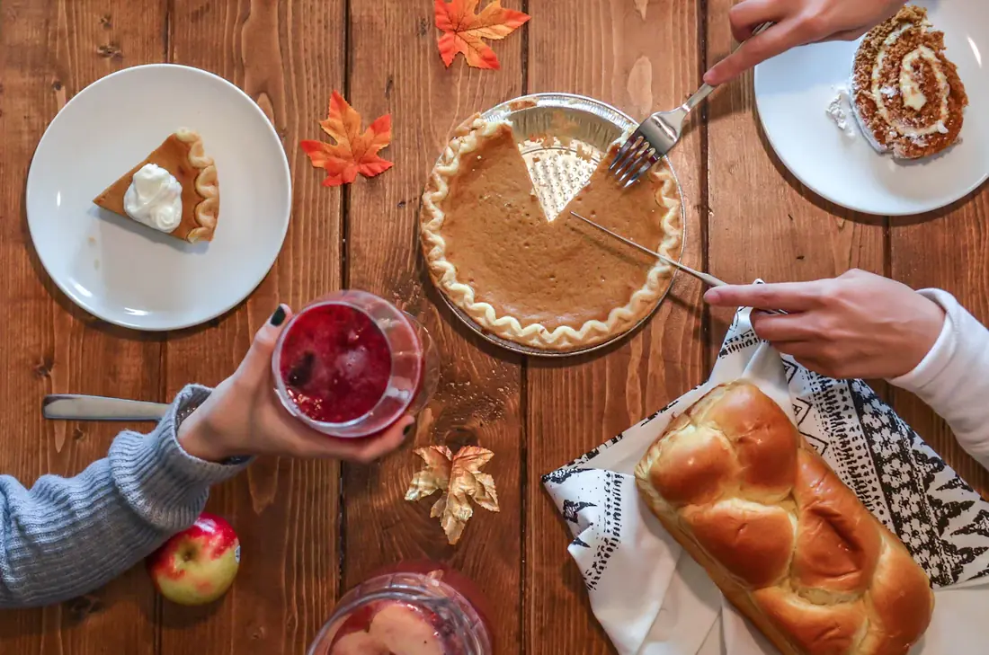 Pumpkin pie and other desserts on a table seen from above